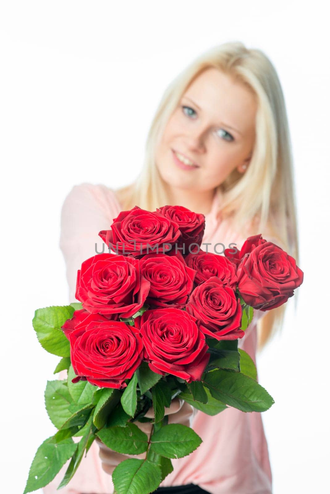 Blonde girl with bouquet of roses