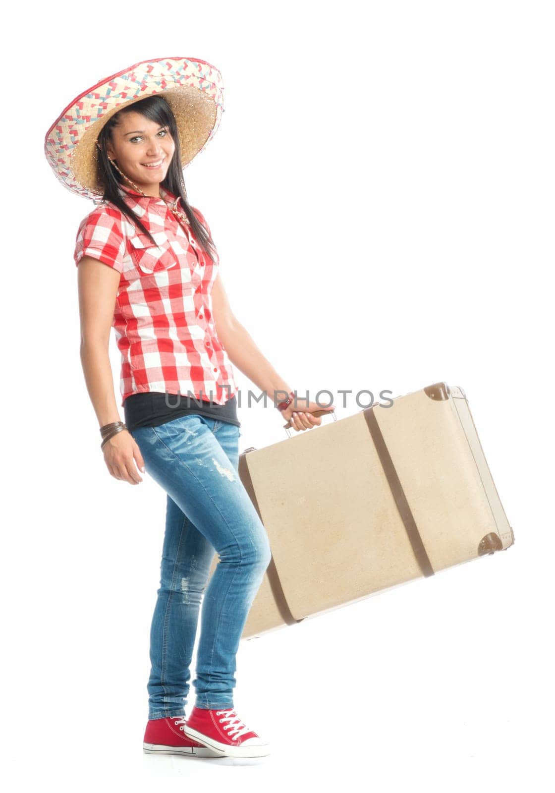 Young girl with sombrero carrying a suitcase