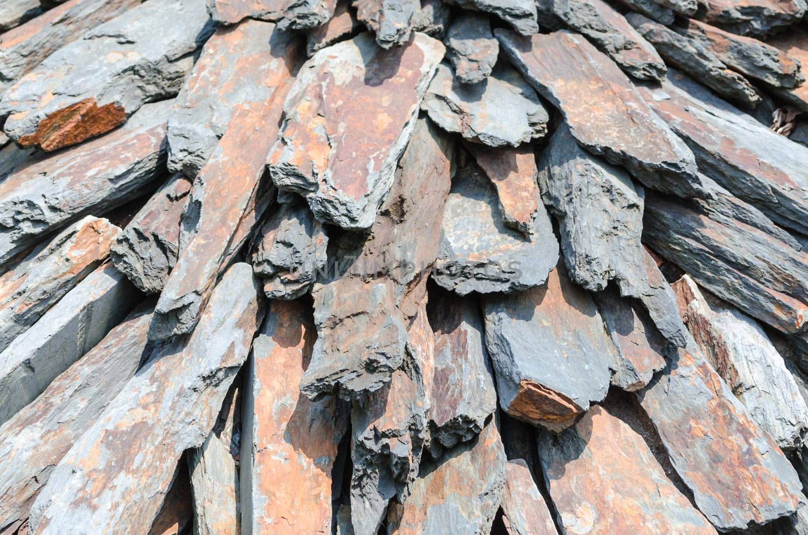 Carefully stacked natural stone slabs on a pile.