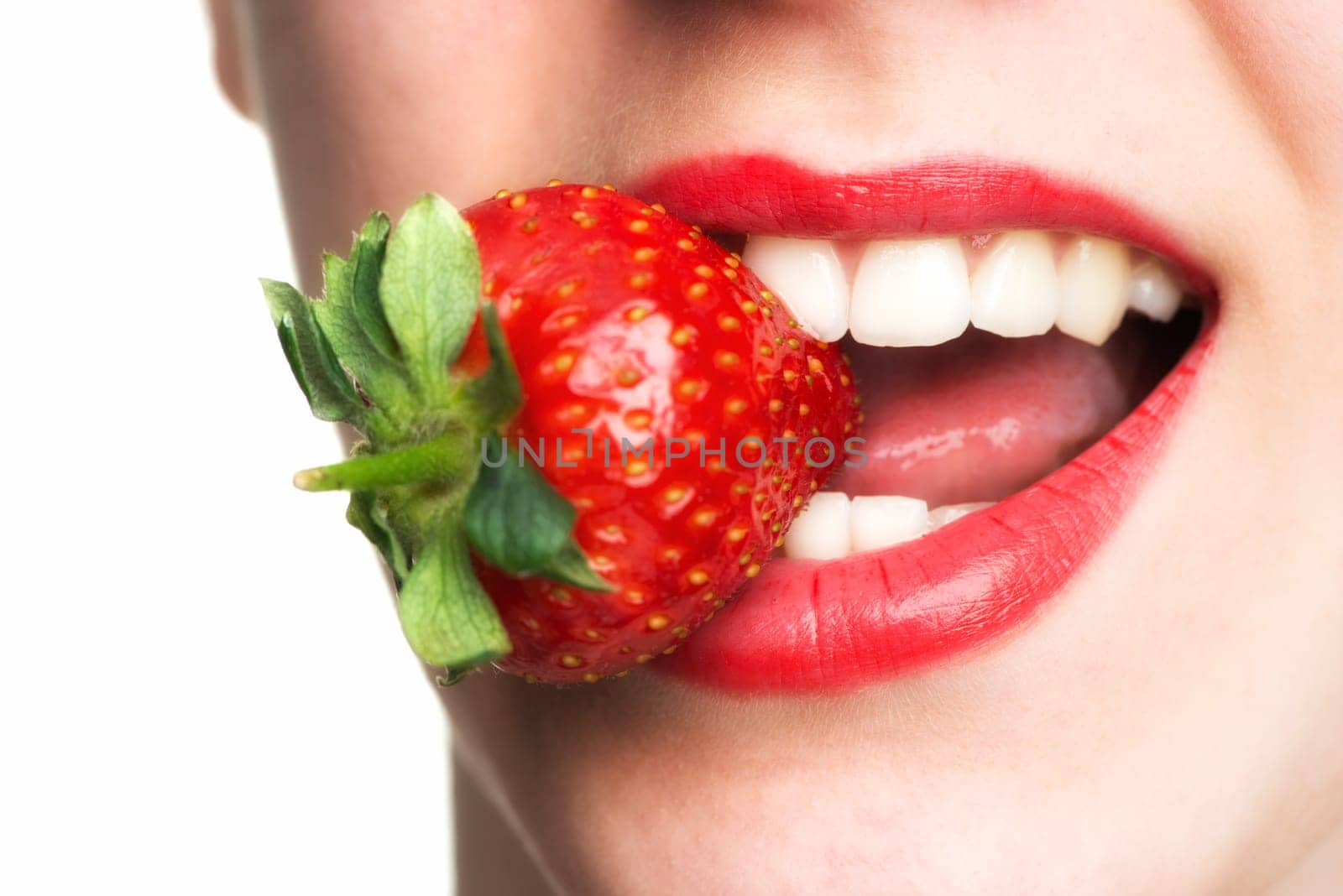 Woman's mouth eats strawberry