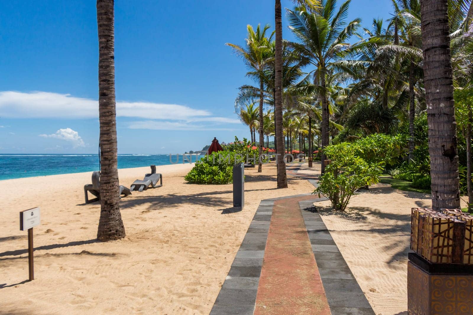 Tropical beach with sun lounger and umbrellas with white sand in the Caribbean