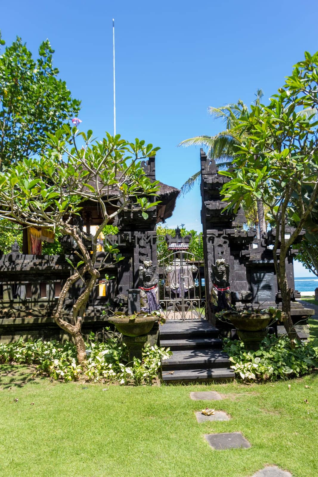 Stairs on a stone wall to an entrance to a house in Bali
