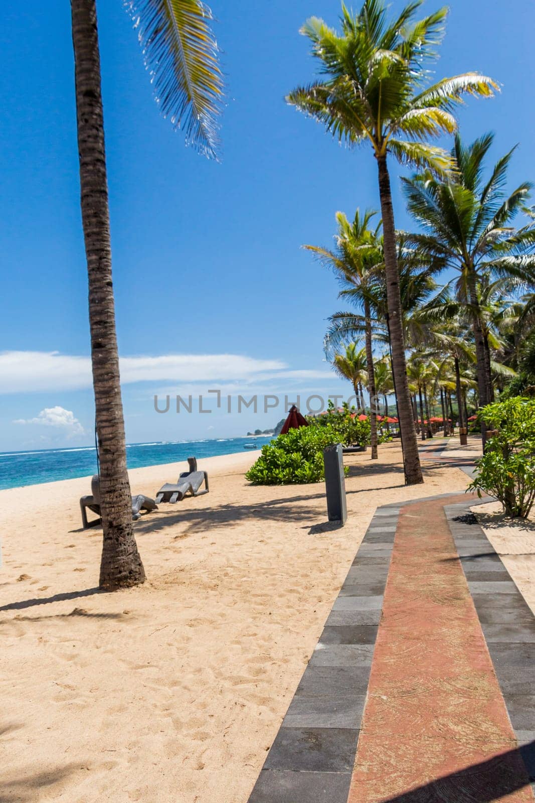 Tropical beach with sun lounger and umbrellas with white sand in the Caribbean
