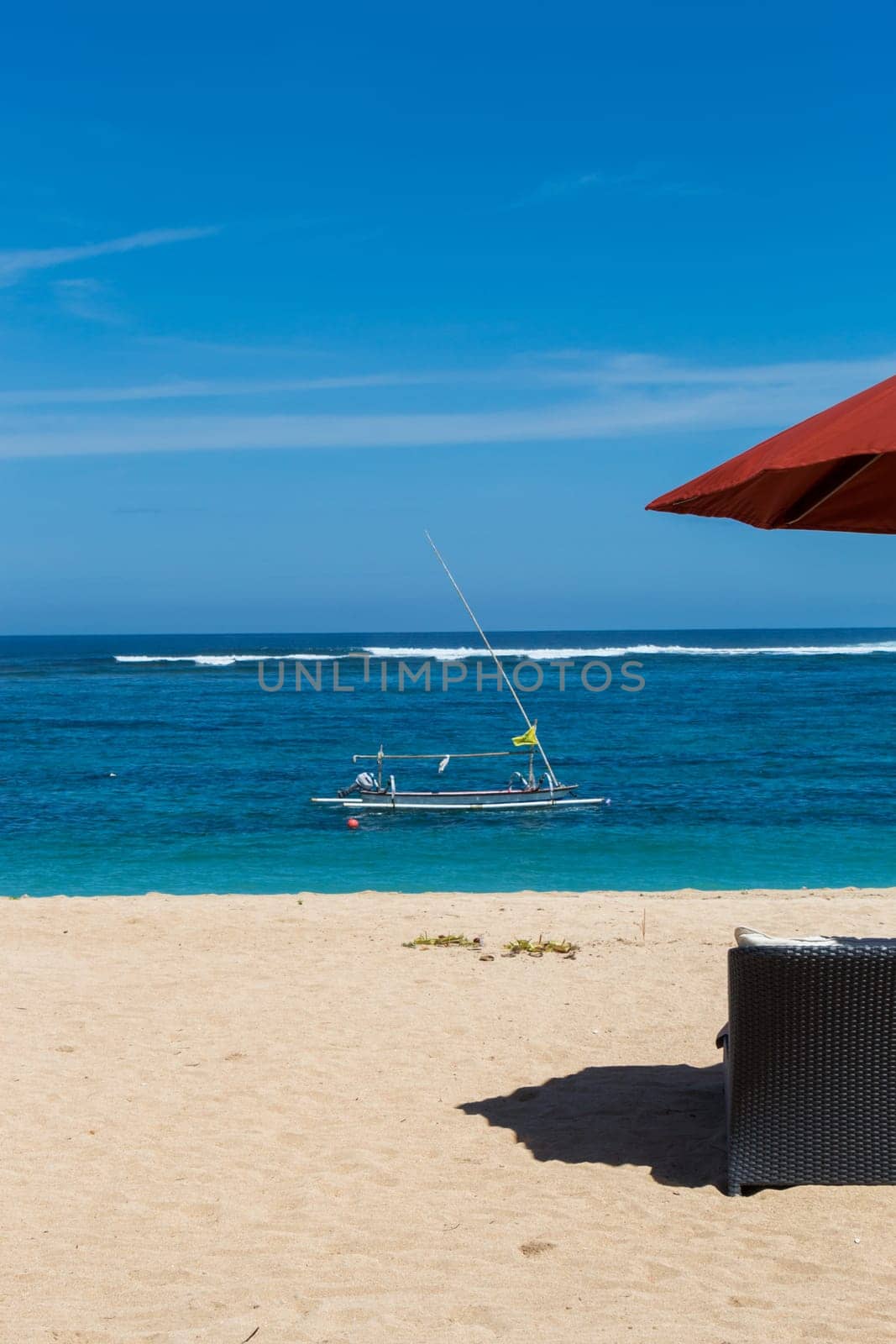 Tropical beach with sun lounger and umbrellas with white sand in the Caribbean