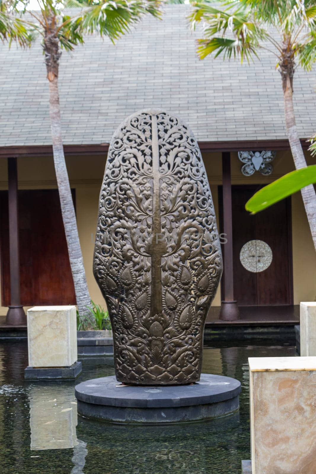 Artful carvings in stone stonemasonry in a green complex in Bali
