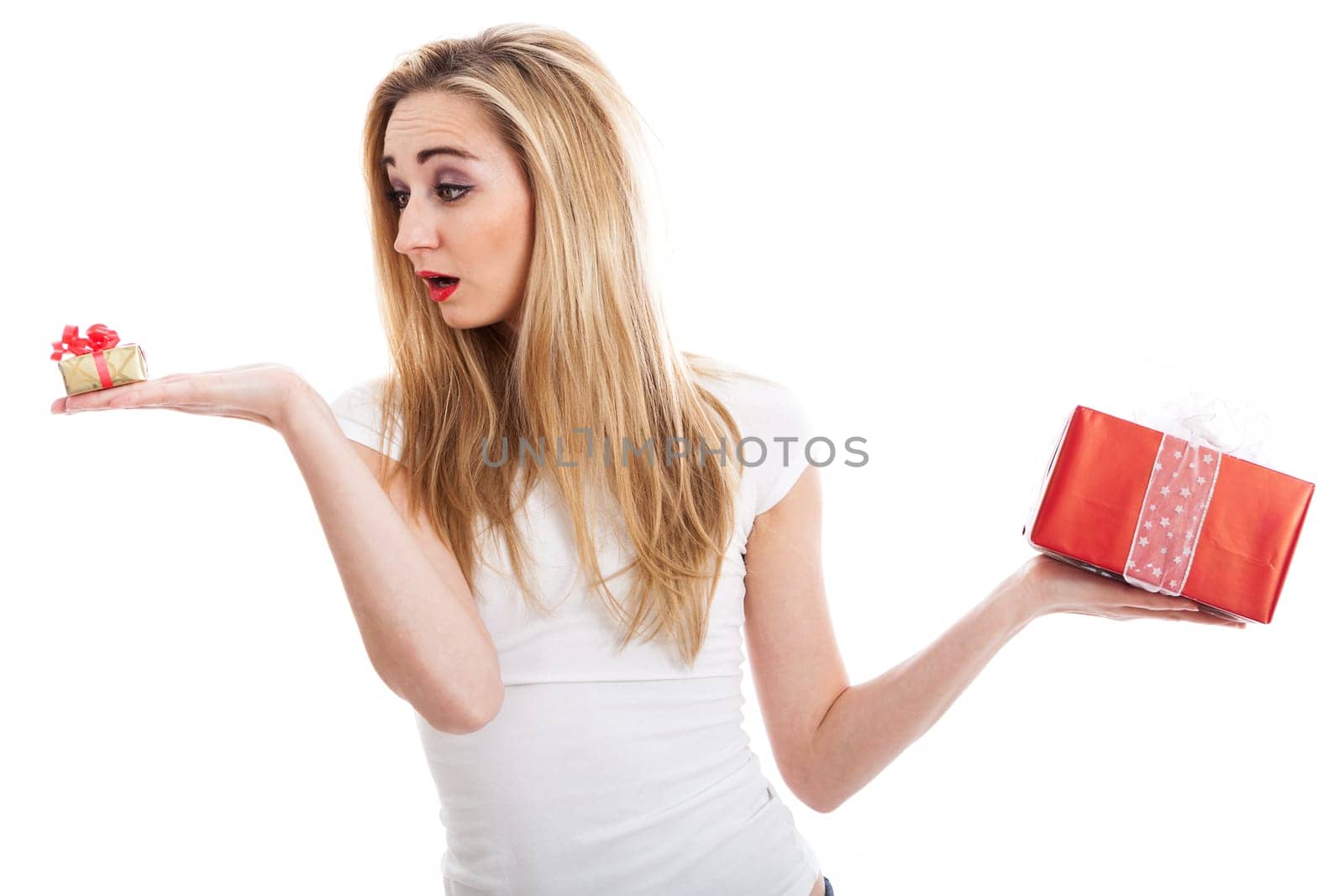 Young attractive woman with gifts rejoices and laughs isolated against white background