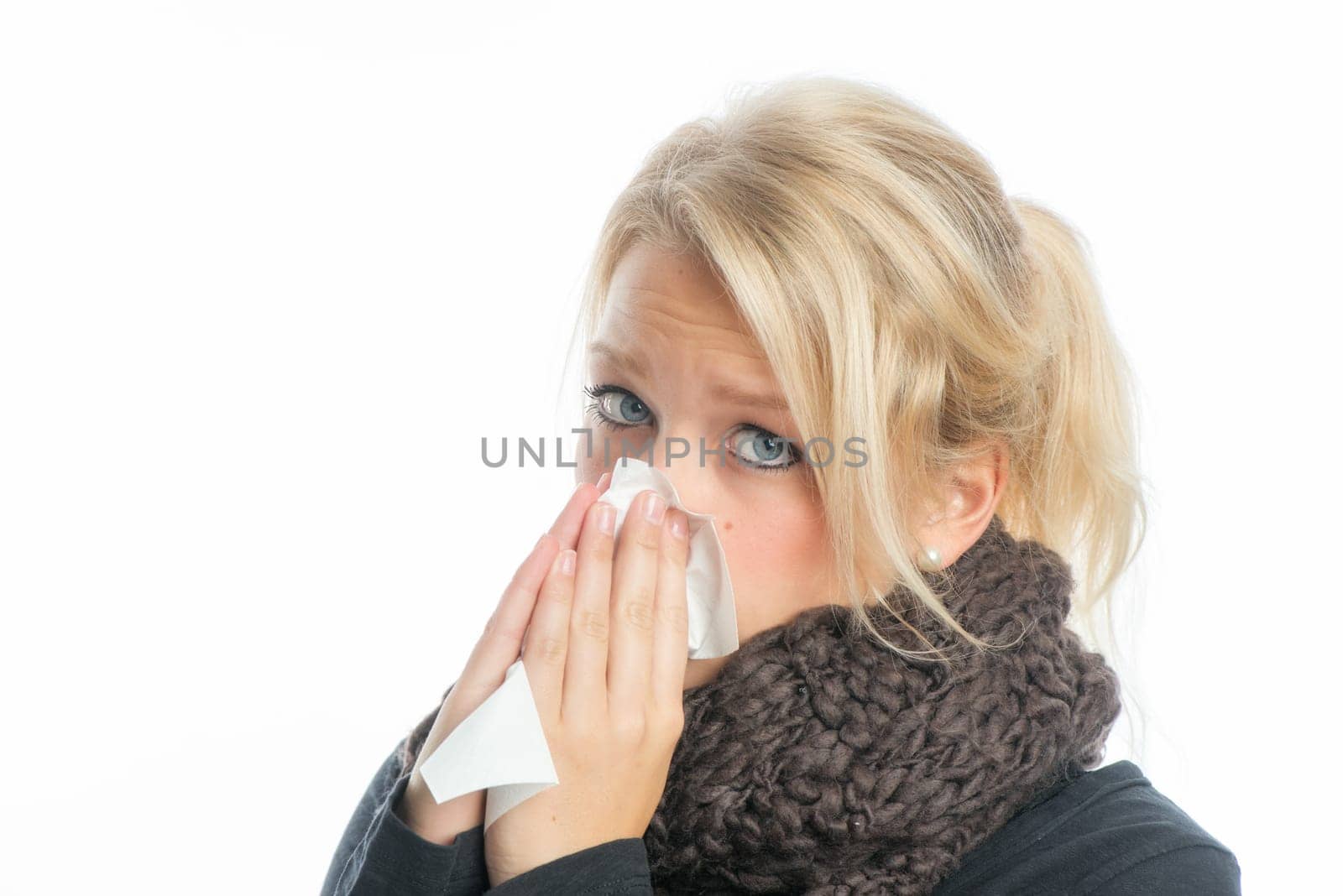 Sick blonde woman with handkerchief