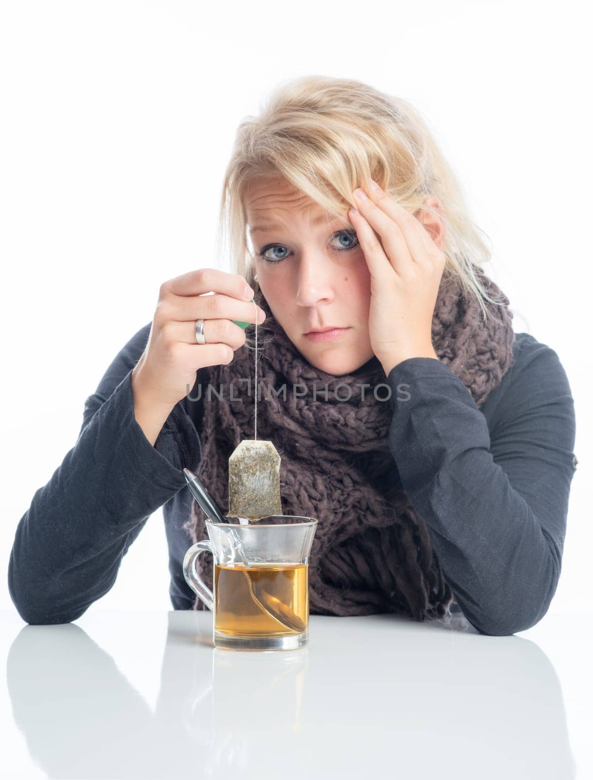 Sick blonde woman drinks herbal tea