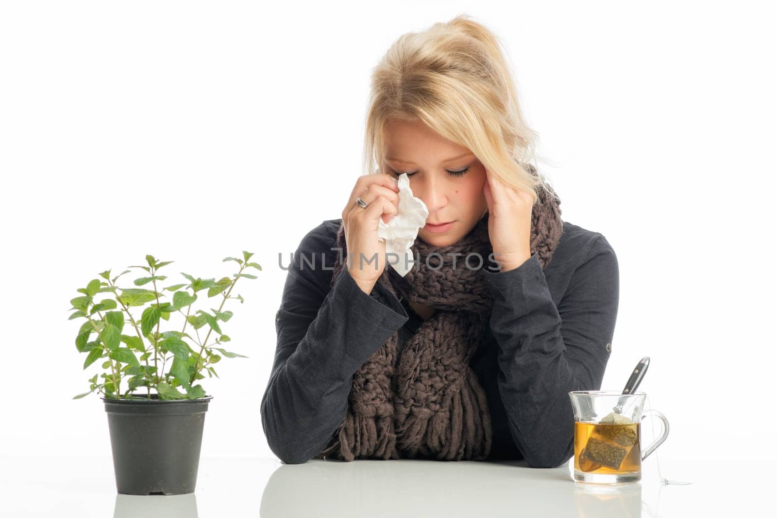 Sick blonde woman drinks herbal tea