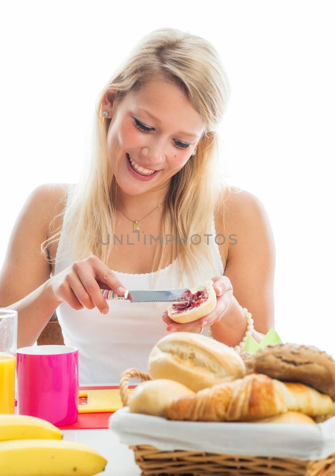 Blonde woman at the covered breakfast table