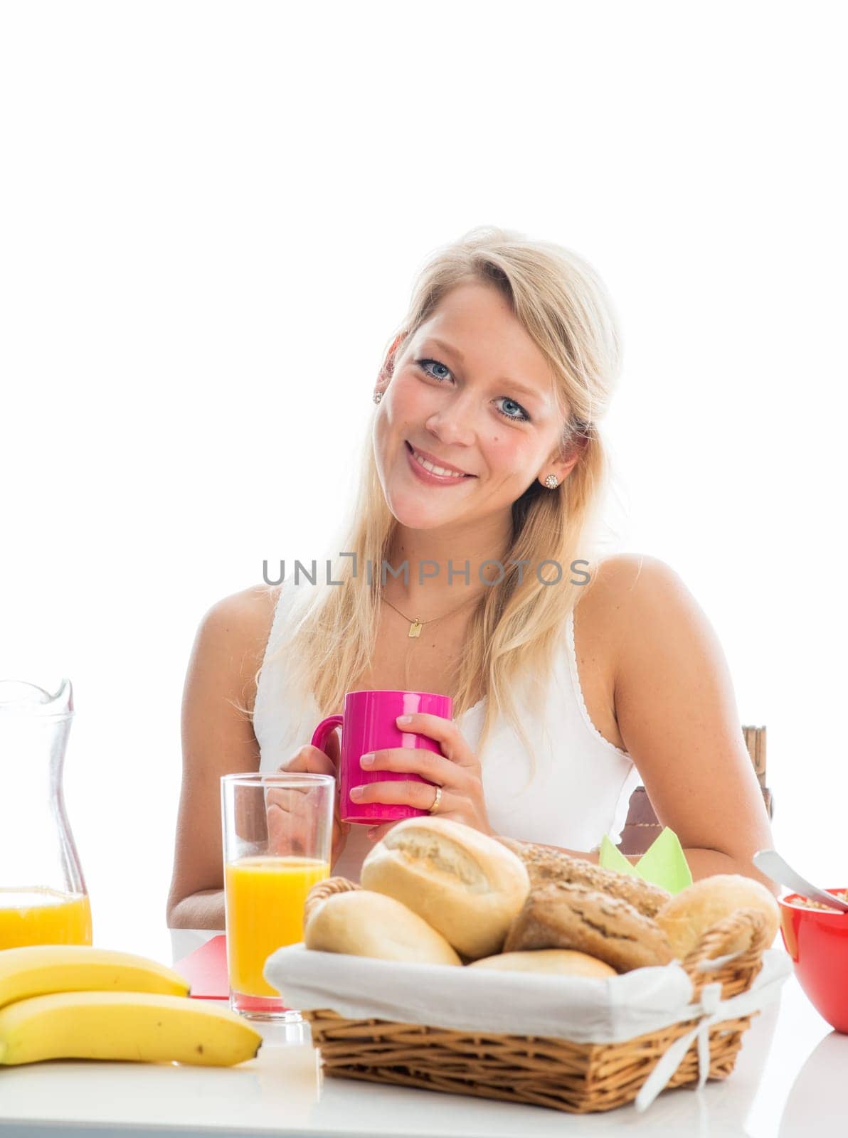 Blonde woman at the covered breakfast table