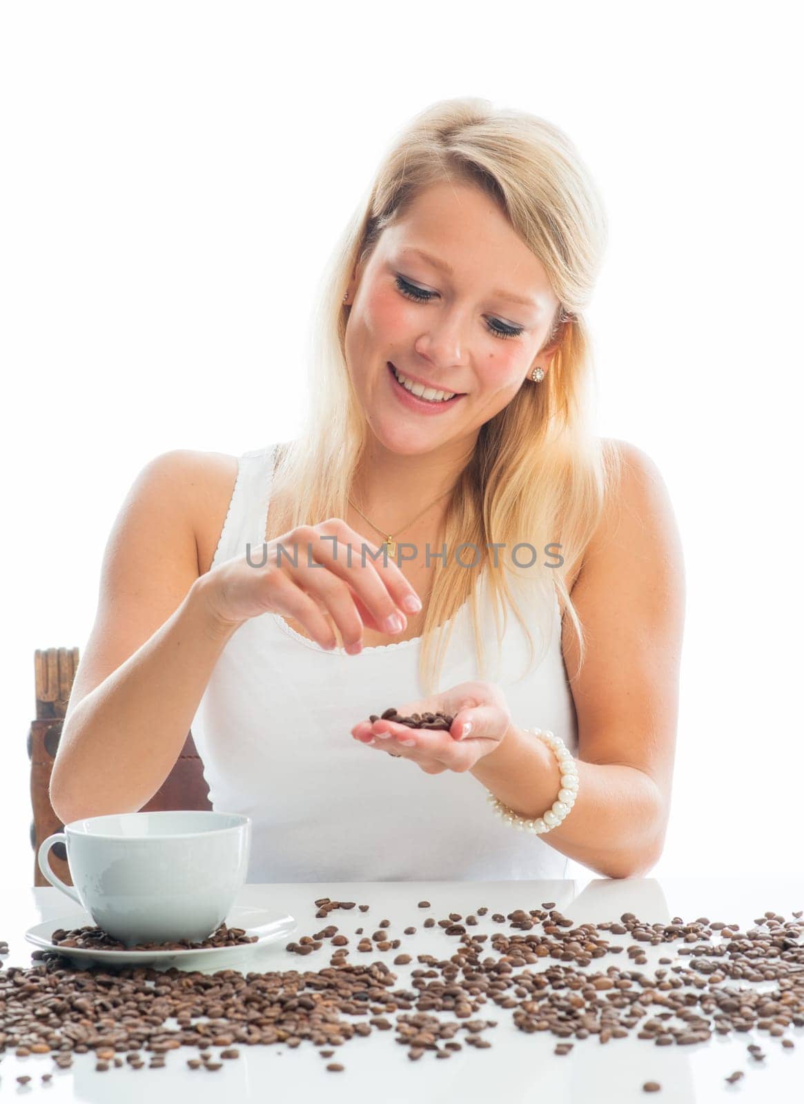 Young woman with coffee beans