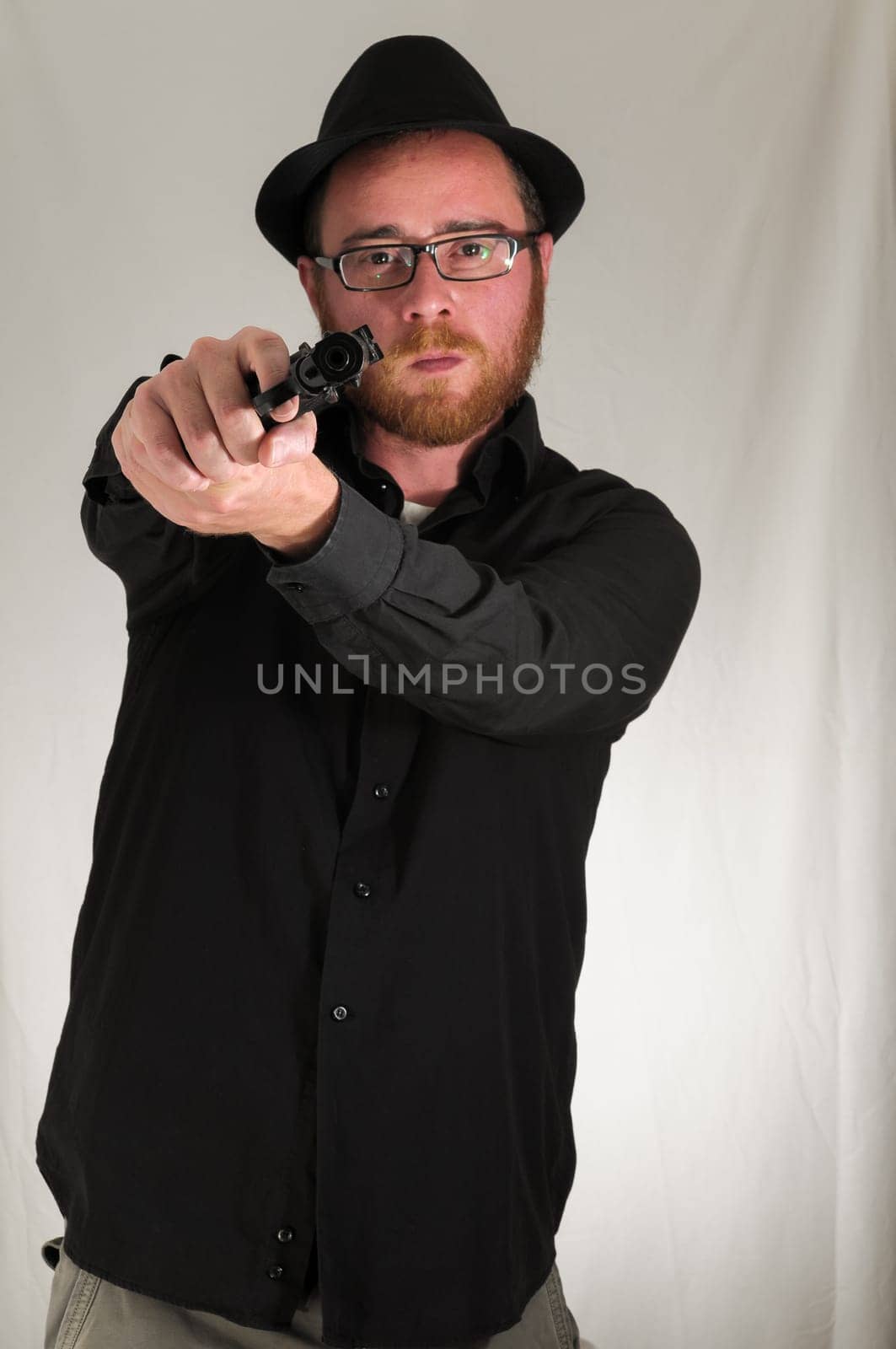 Black Dressed Young Man Holding a Pistol Gun