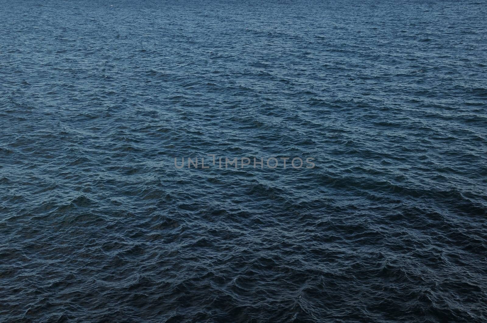 Blue Still Sea Water With Ripple. Natural Background Photo Texture