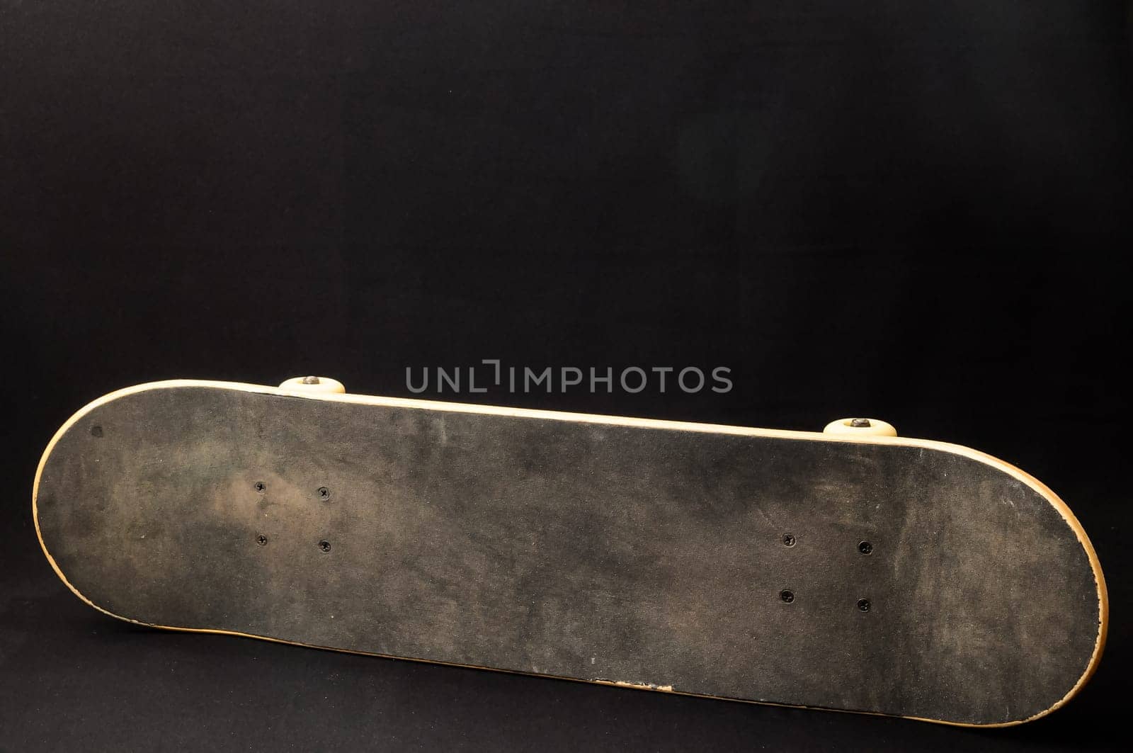 Vintage Style Black Skateboard on a black Background