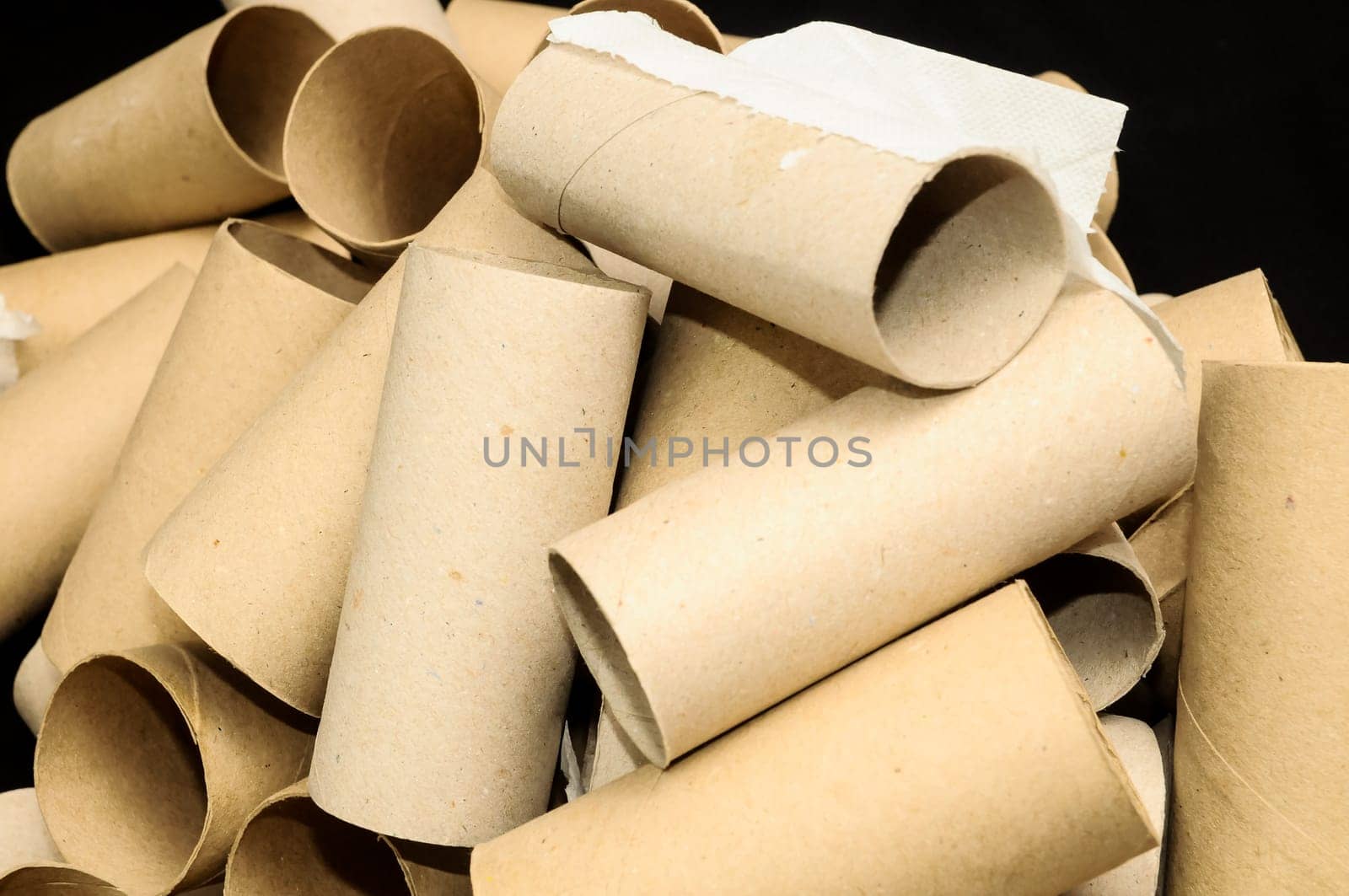 Empty Toilet Rolls Stack Up On a Black Background