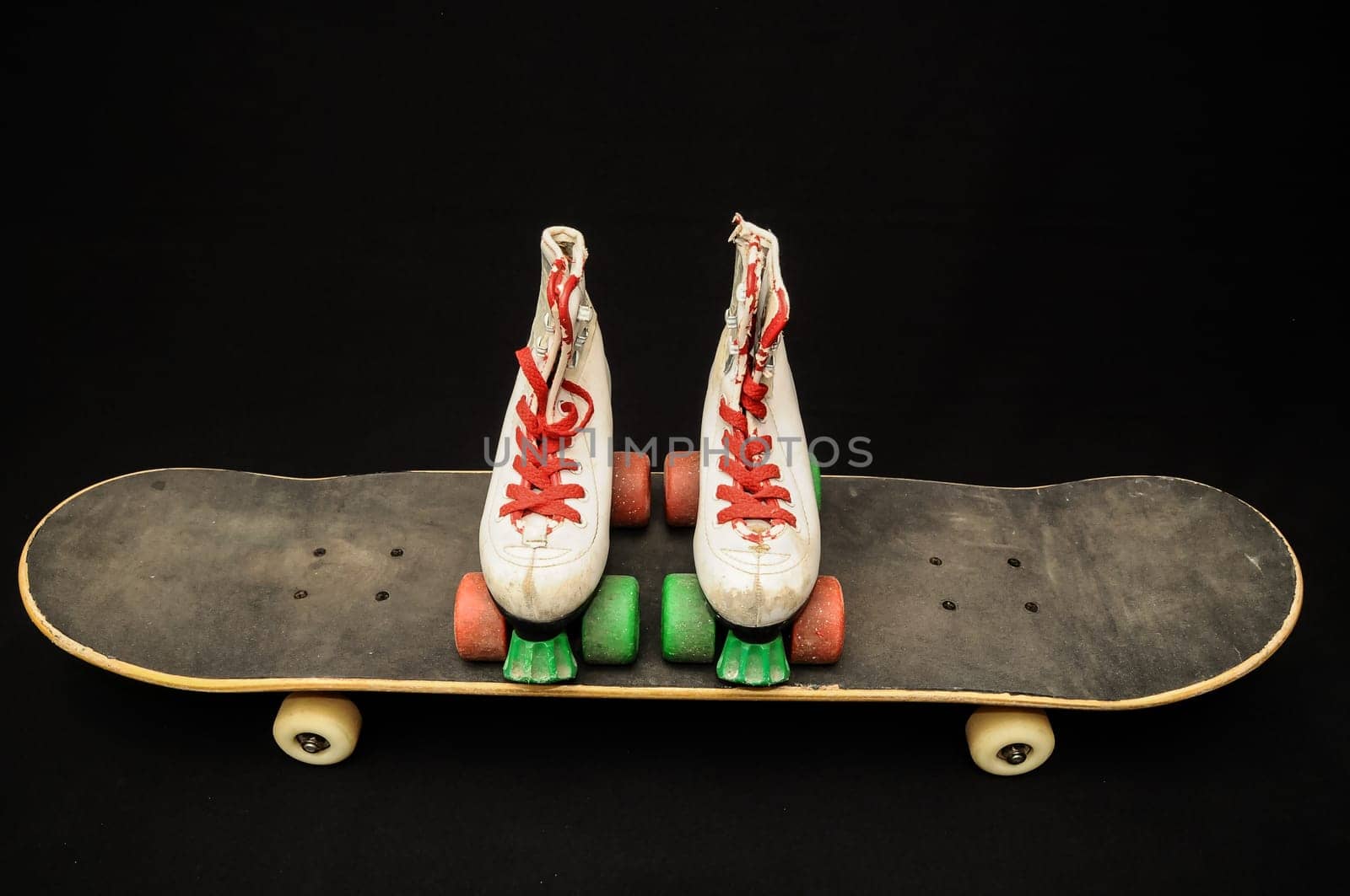 Vintage Style Black Skateboard and Skate Boot on a Dark Background