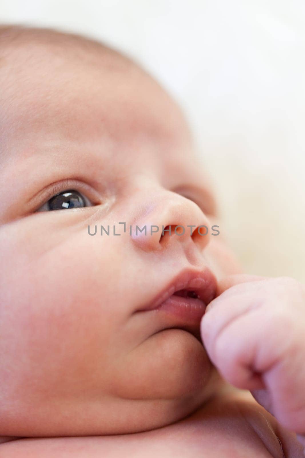 Little baby toddler newborn naked on a white fur as Detal