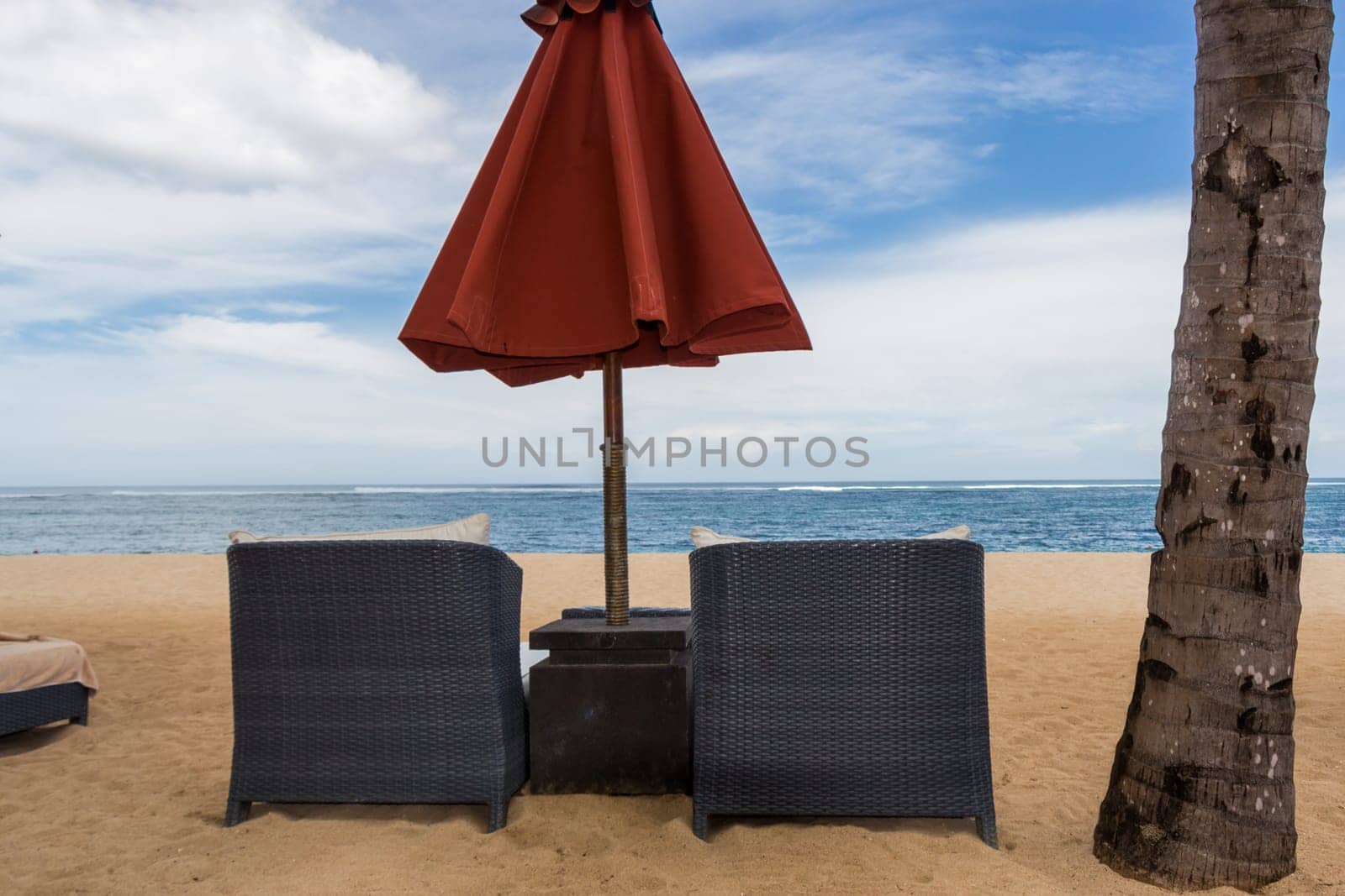 Tropical beach with sun lounger and umbrellas with white sand in the Caribbean