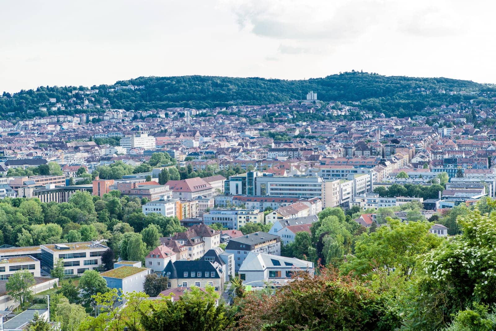 Picturesque view of Stuttgart Germany the modern skyscrapers under the traditional historical architecture overlooking the surrounding hills on a sunny day