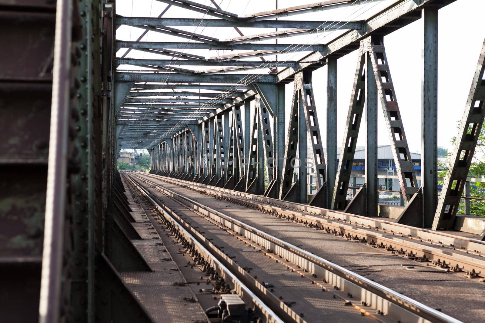 Abandoned bridge with rails for train traffic in daylight