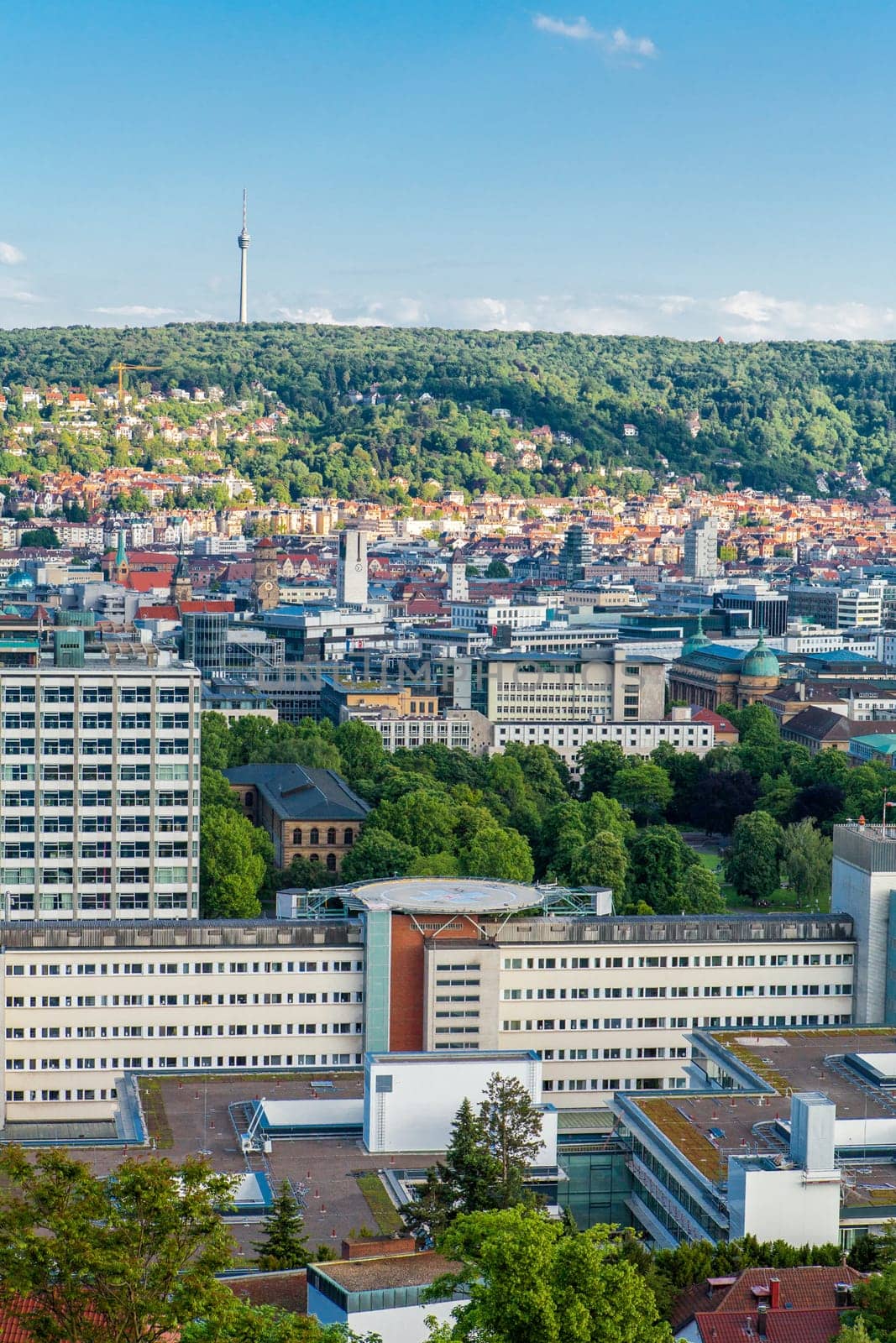 Picturesque view of Stuttgart Germany the modern skyscrapers under the traditional historical architecture overlooking the surrounding hills on a sunny day