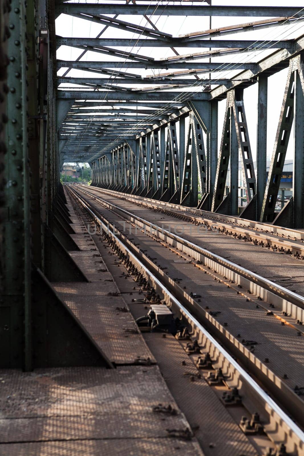Abandoned bridge with rails for train traffic in daylight