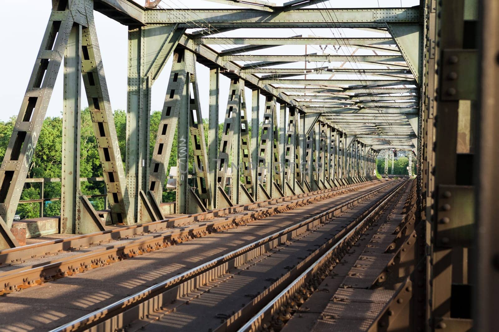 Abandoned bridge with rails for train traffic in daylight