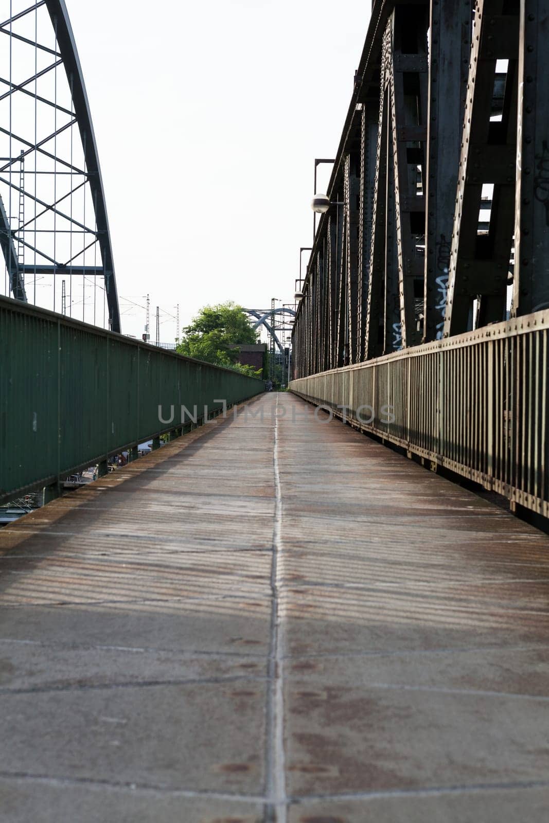 Abandoned bridge with rails for train traffic in daylight