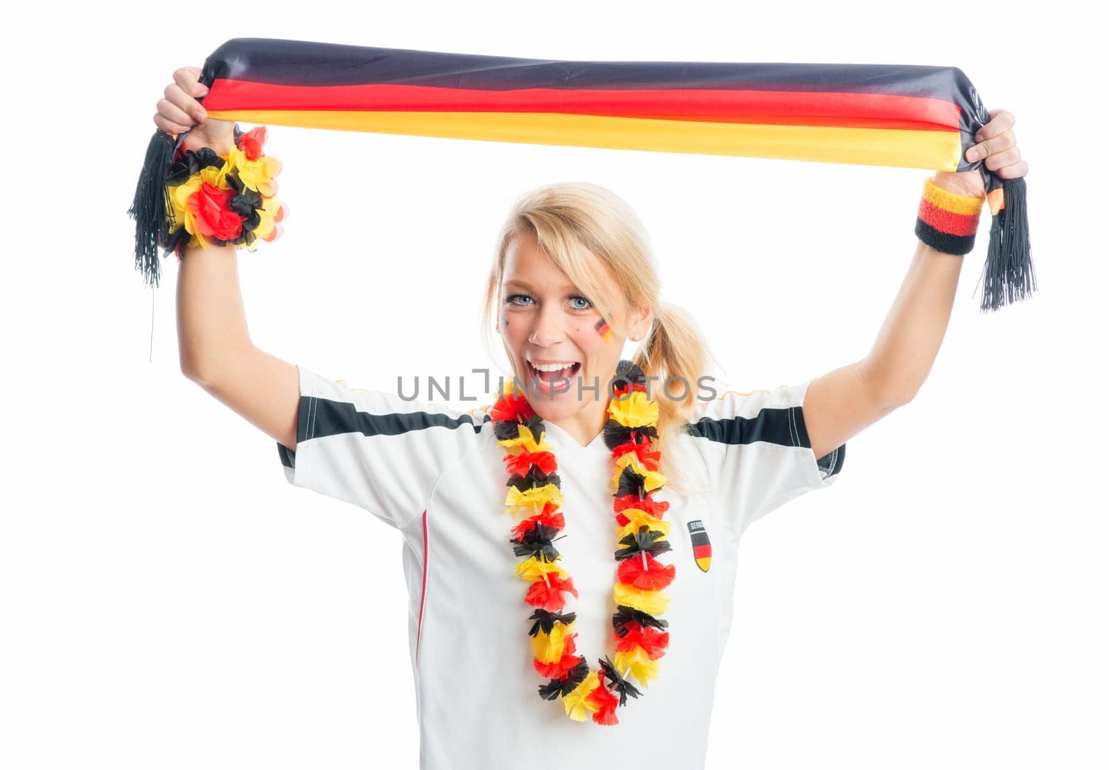 Blonde football fan holds up a fan scarf