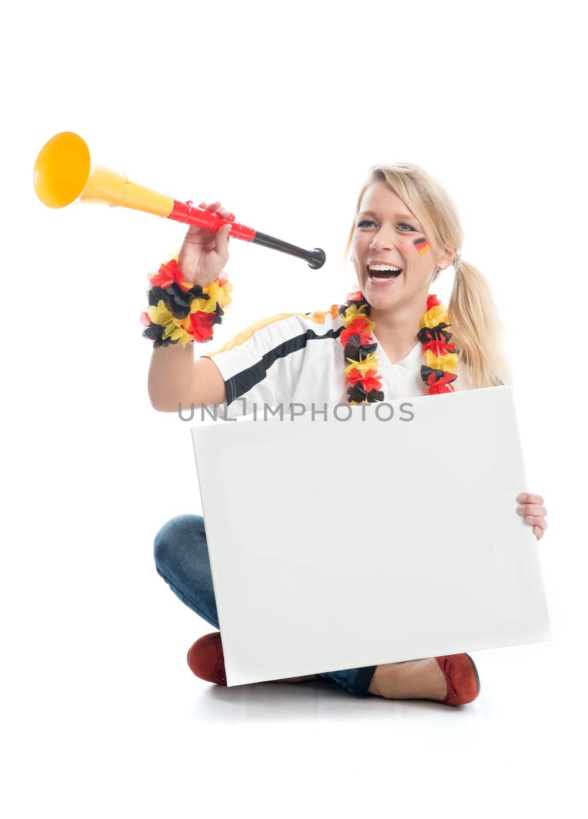 Blonde football fan with Vuvuzela holds a poster