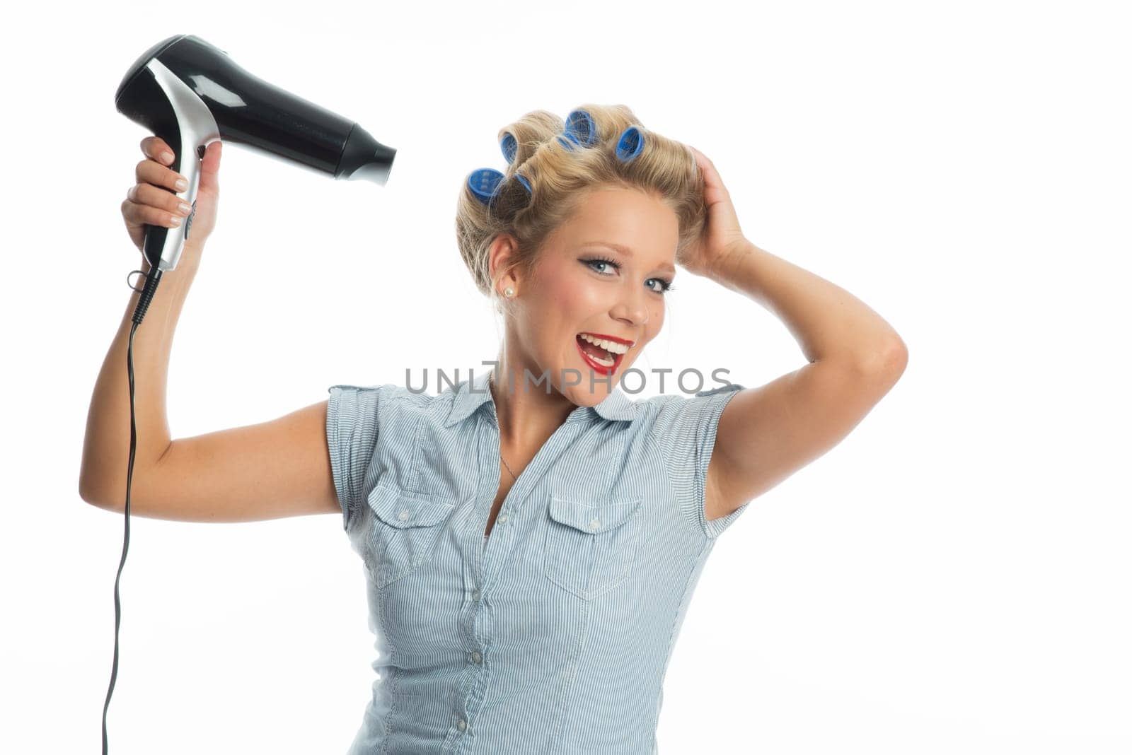 Blonde woman blow-drys hair