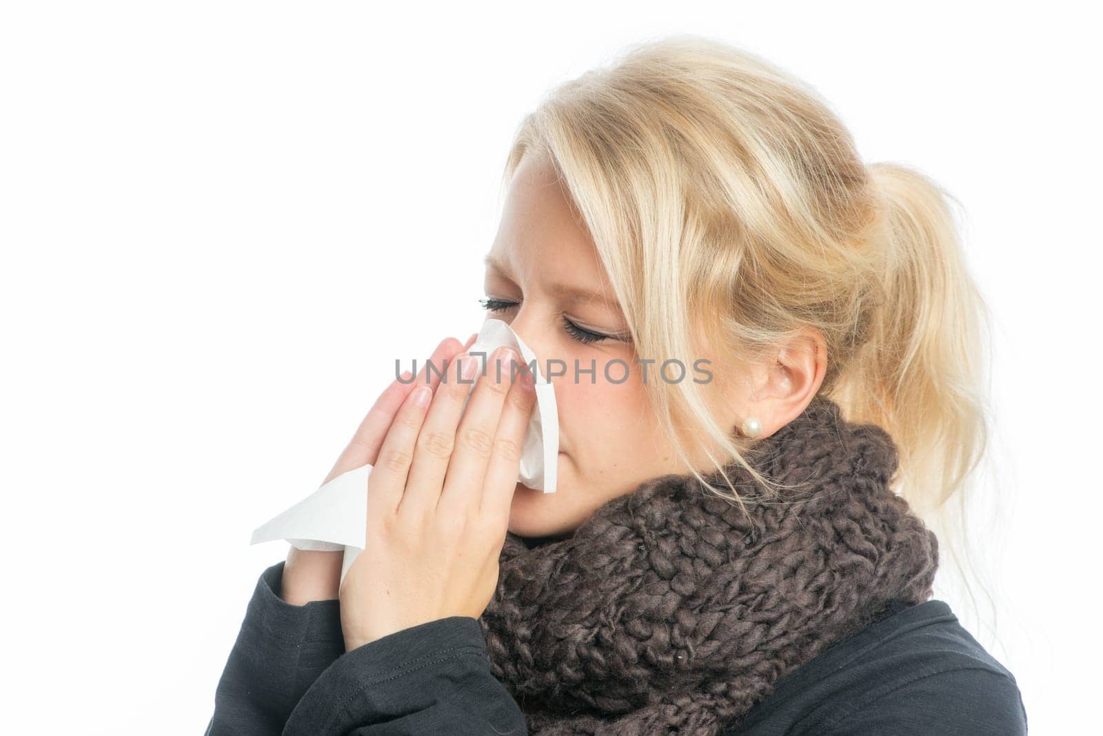 Sick blonde woman with handkerchief
