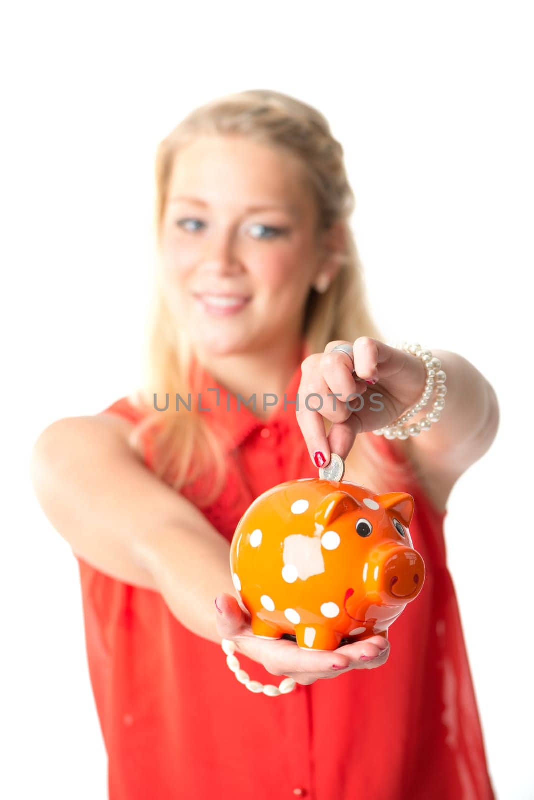 Blonde woman with piggy bank