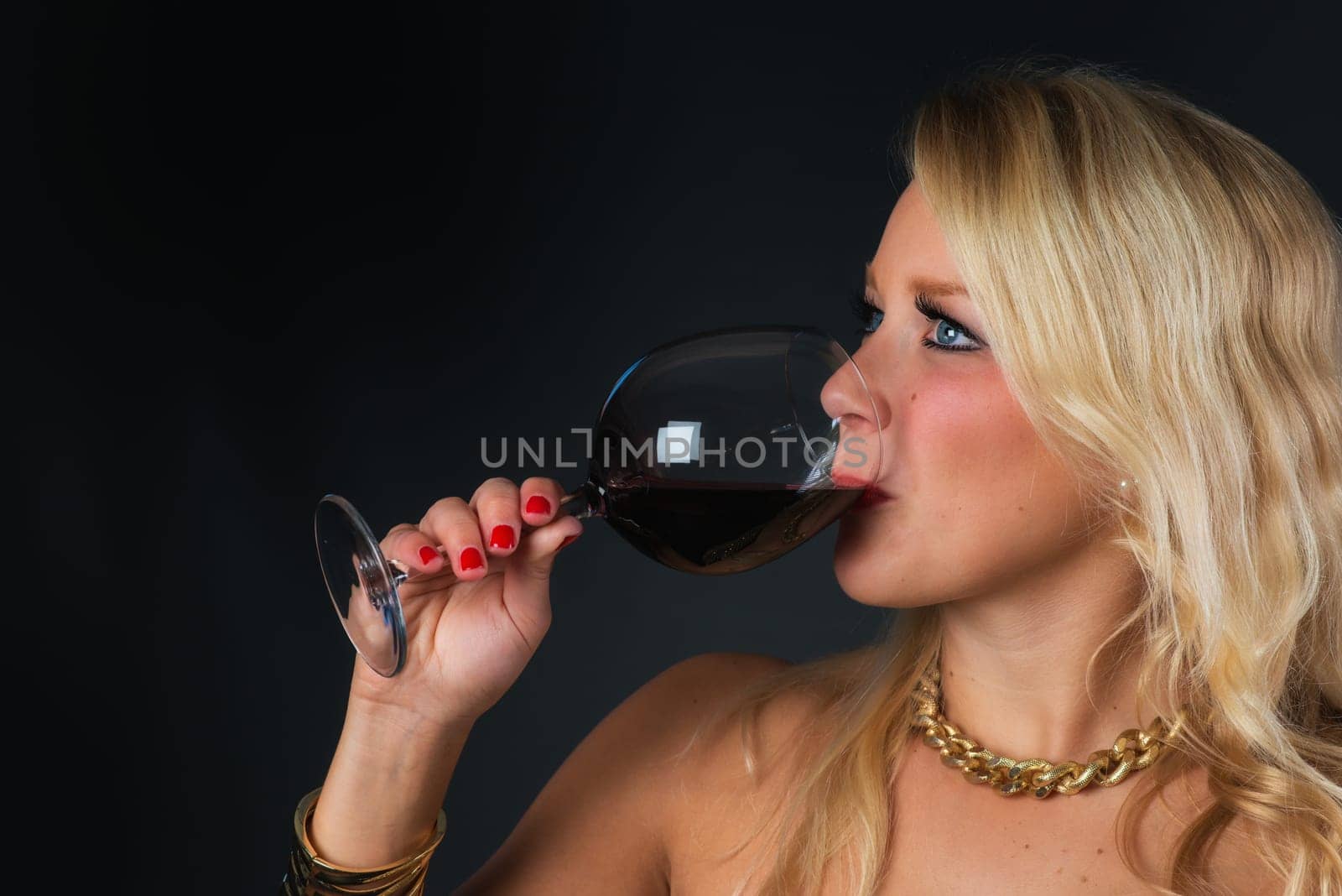 Elegant woman with red wine in glass