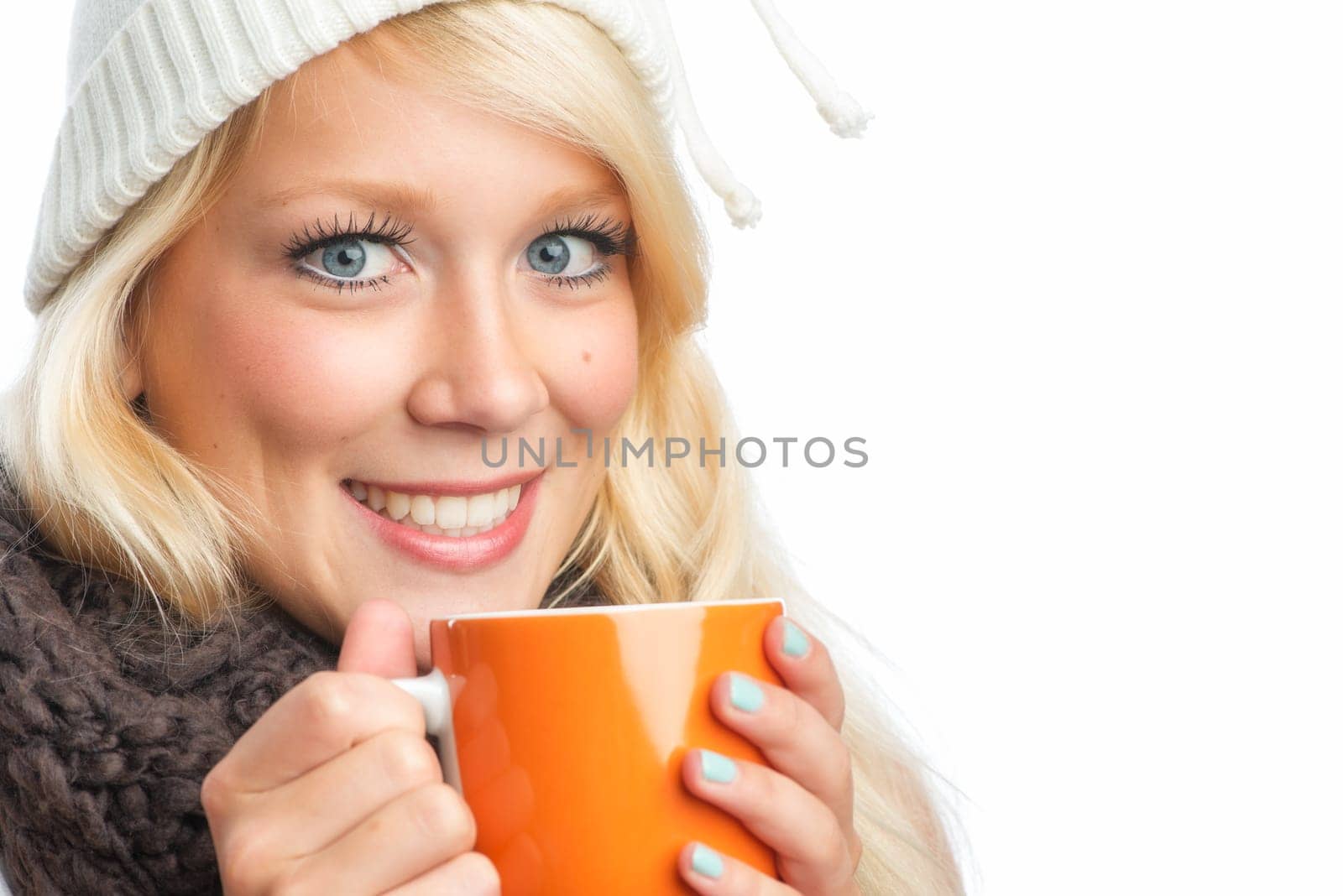 Blonde woman drinks from a mug