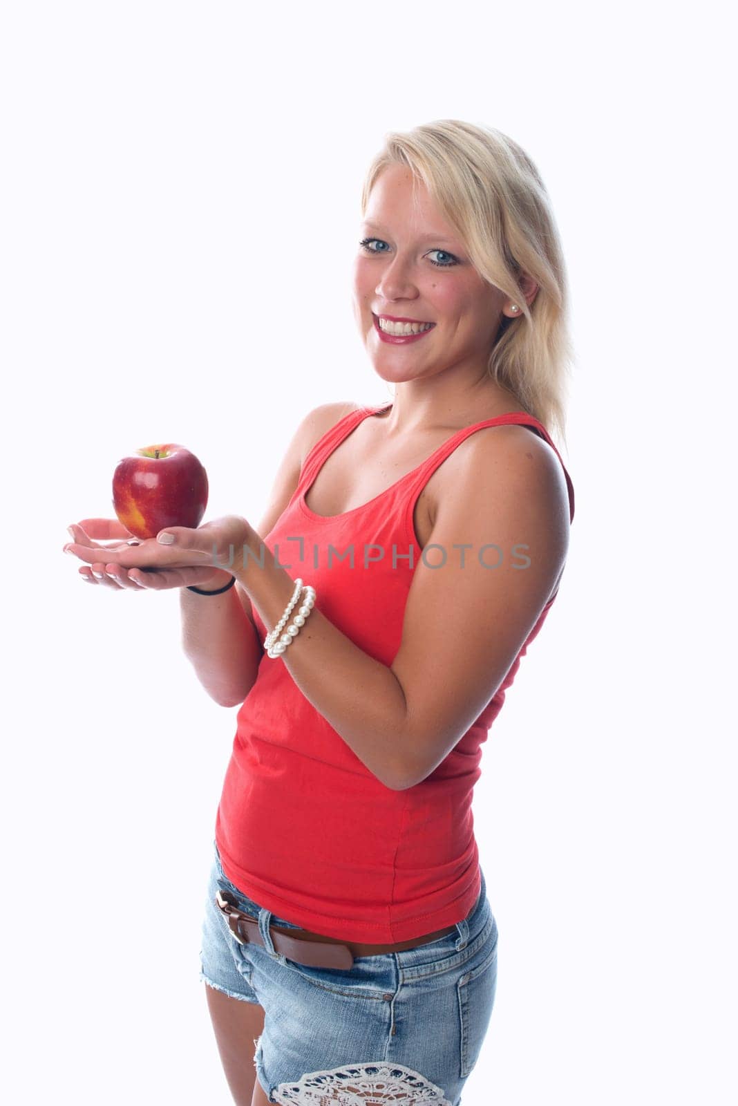 Blonde woman holds a red apple