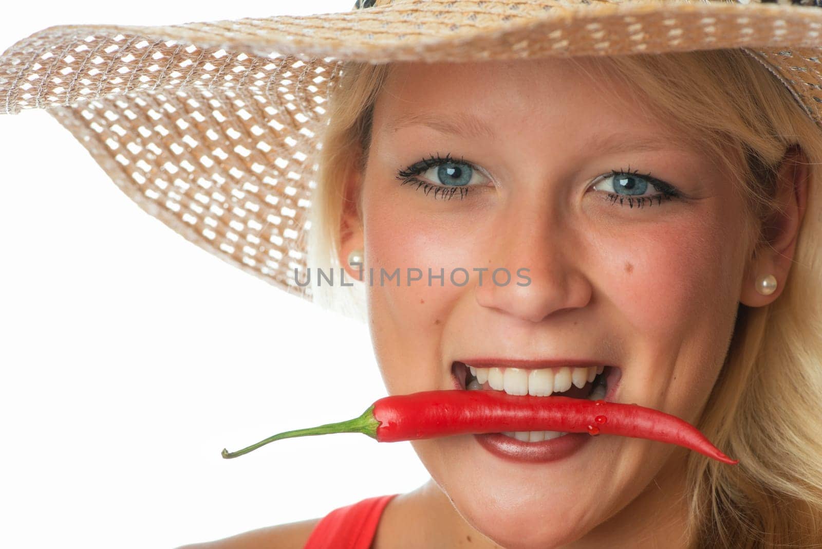 Woman bites in chilli pepper