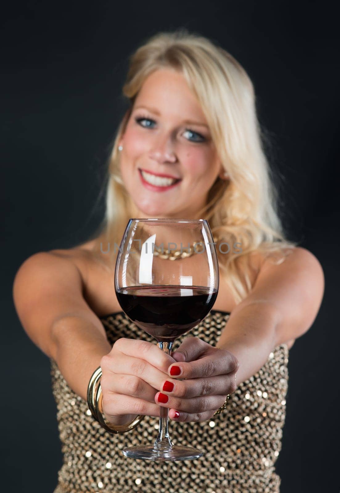 Elegant woman with red wine in glass
