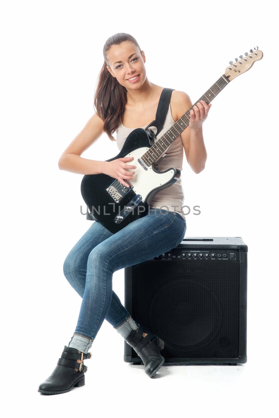 Young girl with electric guitar and amplifier