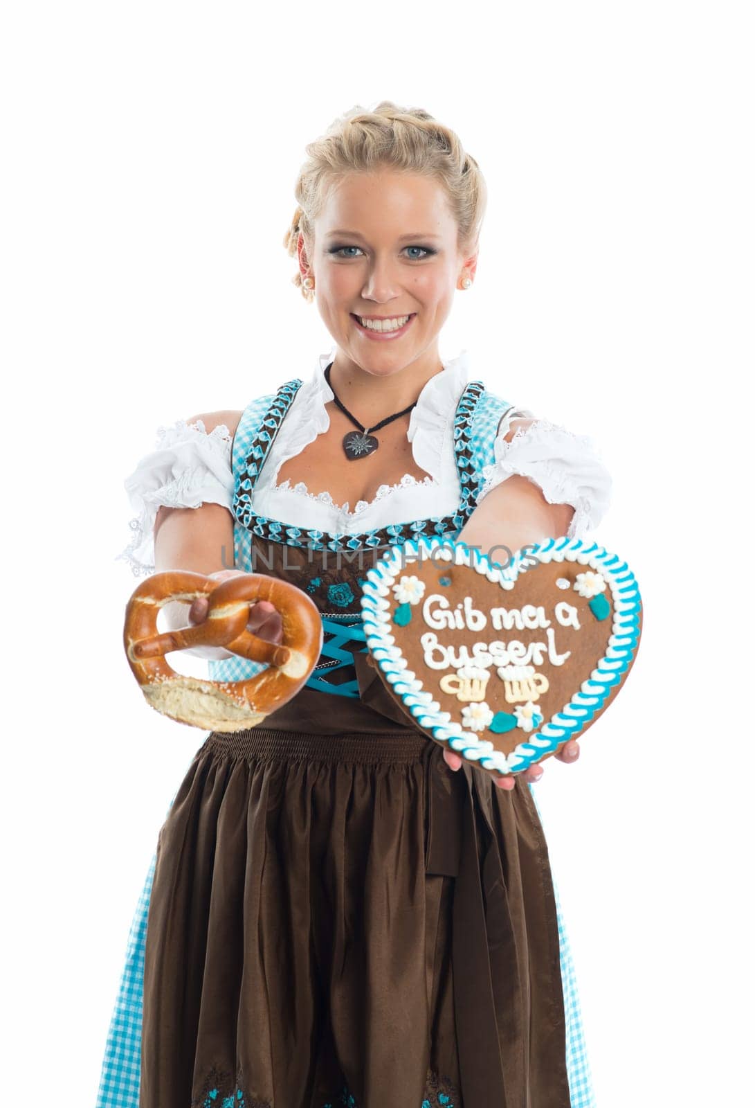 Bavarian girl with gingerbread heart and Brezn