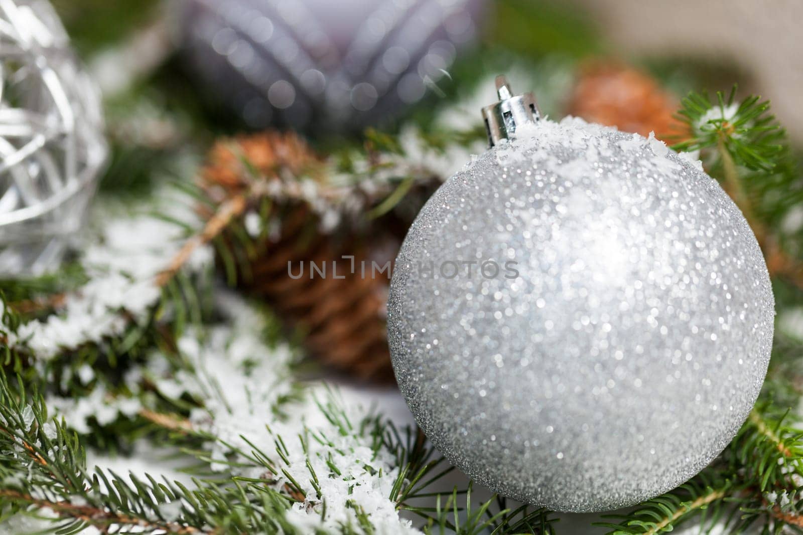 Silver Christmas bauble jewelry with deer and fir branches decoration for Christmas as macro detail