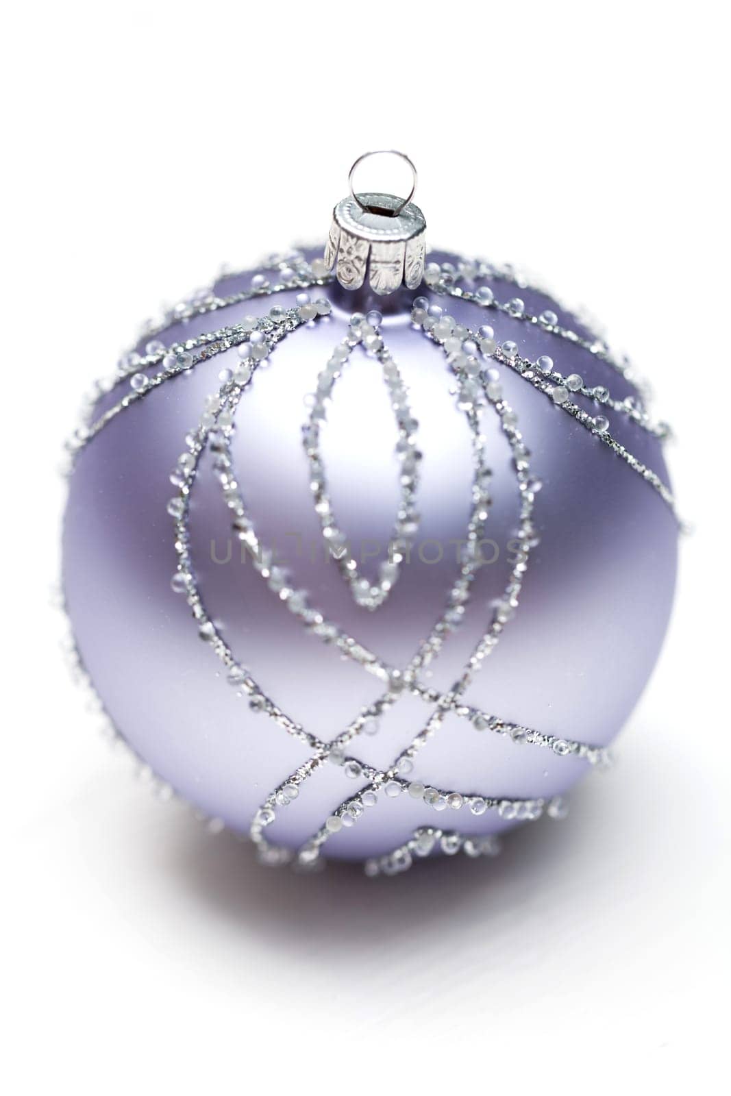 Glittering silver Christmas bauble on white background Macro detail