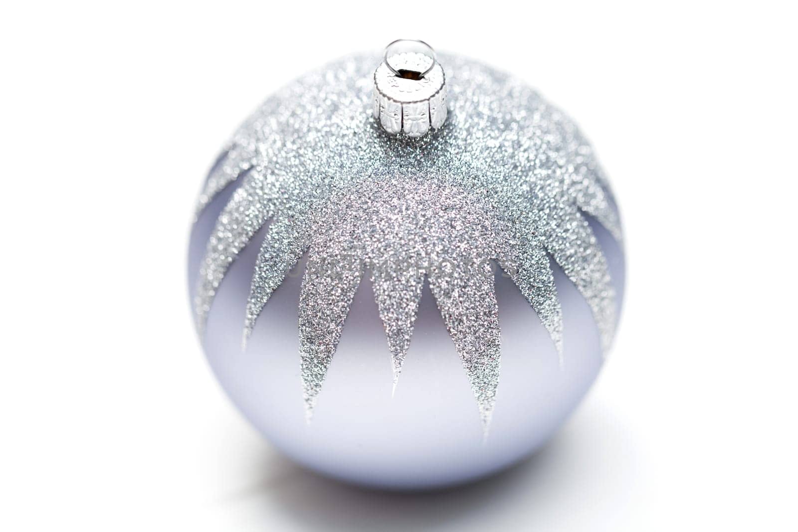 Glittering silver Christmas bauble on white background Macro detail