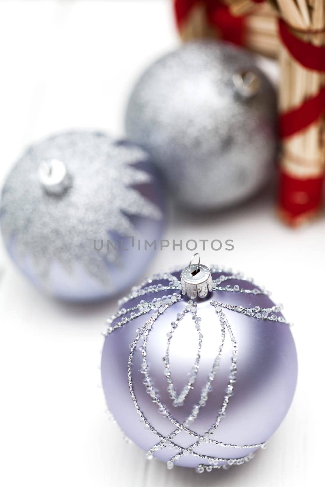 Glittering silver Christmas bauble on white background Macro detail