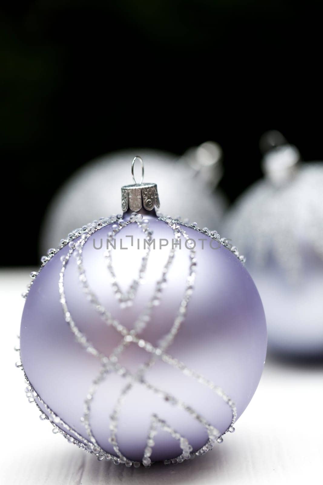 Glittering silver Christmas bauble on white background Macro detail