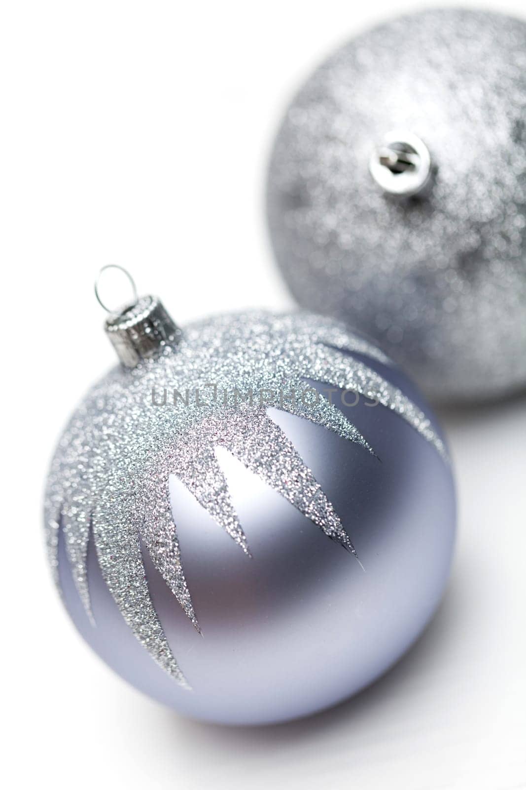 Glittering silver Christmas bauble on white background Macro detail
