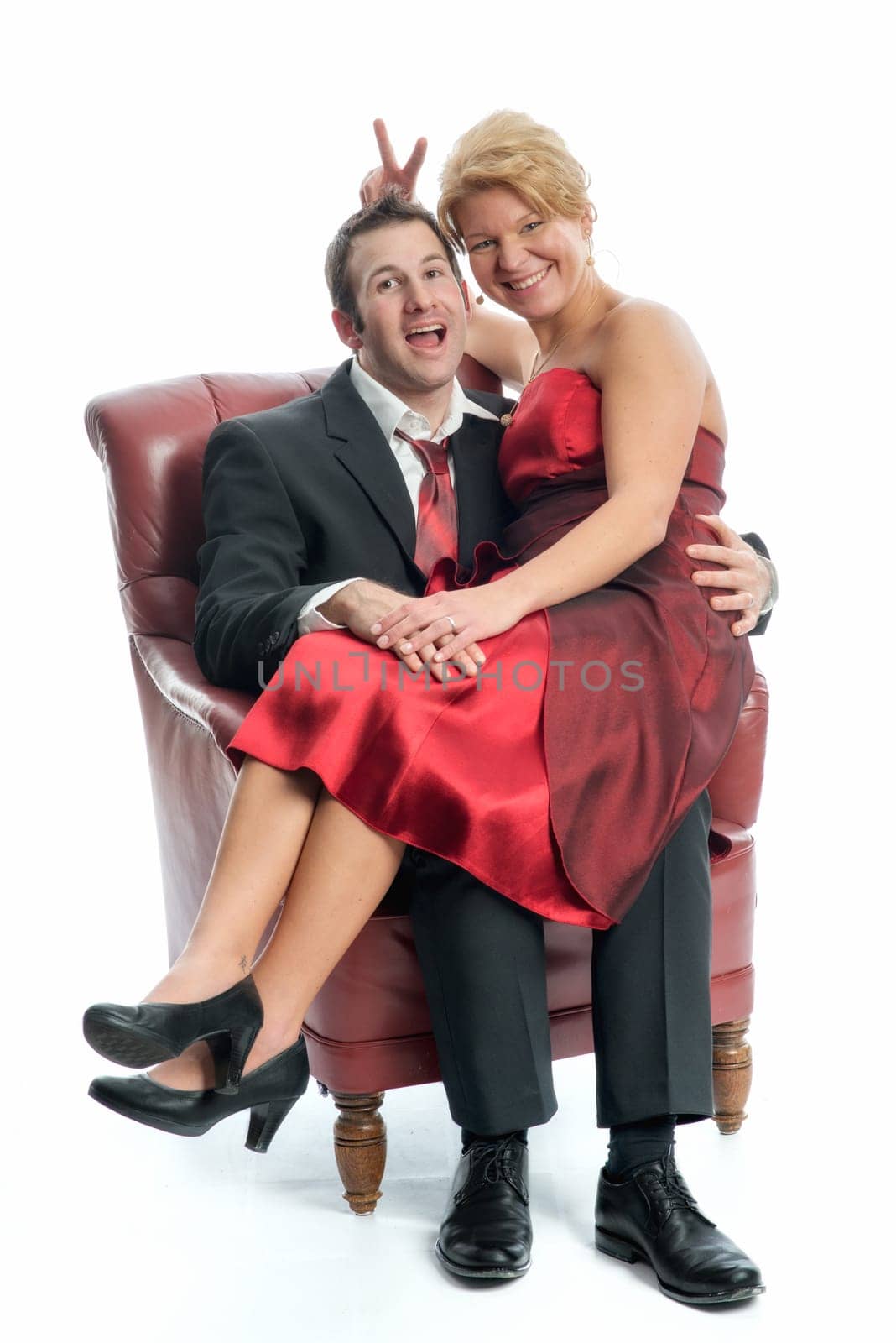 Couple in love sits on an armchair
