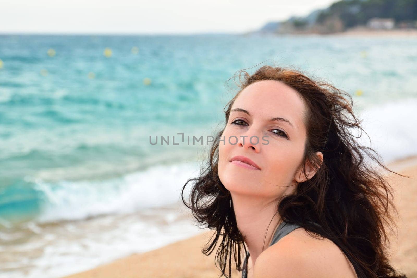 Cute woman sitting on the beach