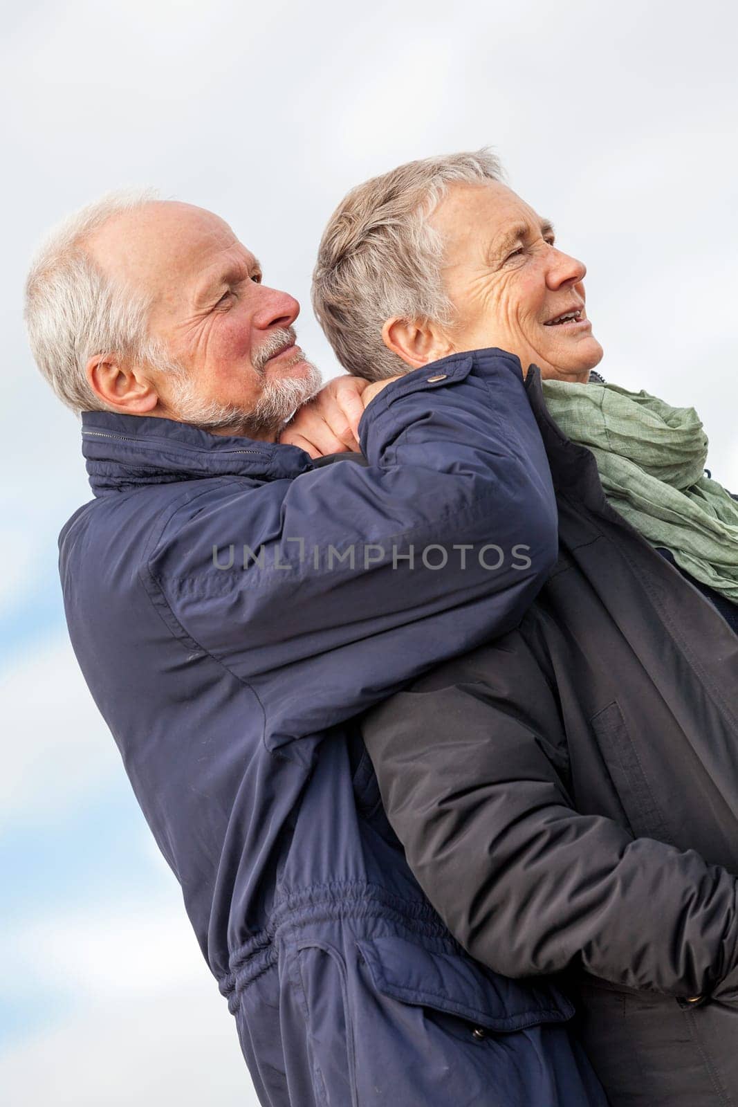 older adult happy couple walks on the beach in autumn lifestyle happiness